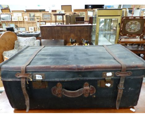 A LEATHER TRIMMED BLACK CANVAS TRUNK