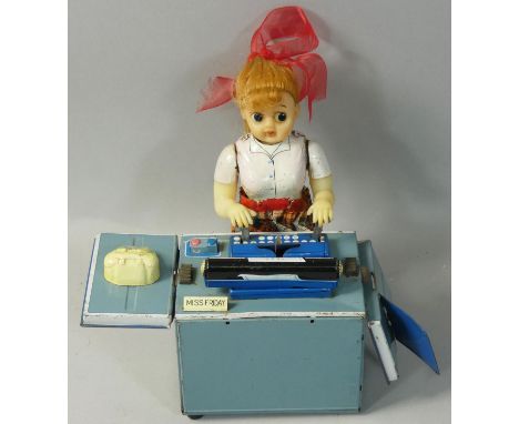 A vintage battery operated tin plate and plastic typing secretary 'Miss Friday', height 18cm. 