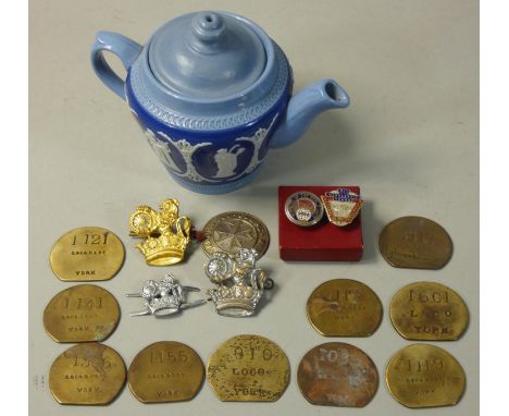 A miscellaneous collection to include, 10 York paychecks, 2 NUR badges, 3 railway cap badges and small LNER decorative teapot