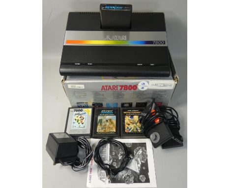 A boxed Atari 7800 video game system, with power supply unit, two mini-stick controllers and television lead, additional game