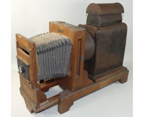 A mahogany plate&nbsp;slide projector by Westminster Photographic Exchange Ltd., applied brass makers plaque, with adjustable