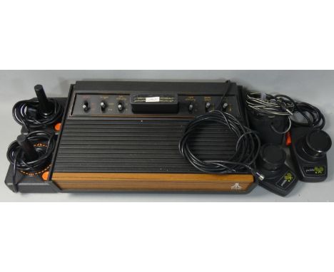 An Atari 2600A video games console nicknamed Woody, together with original 'Combat' cartridge, Atari power supply unit, two A