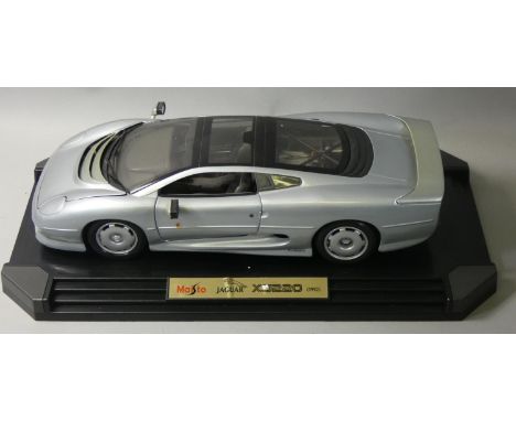 A boxed Maisto model of a Jaguar XJ220 (1992) race car, 1:12 scale, finished in metallic silver, hused in the original polyst