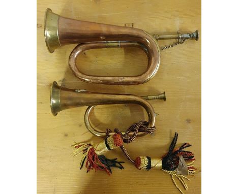 A War Department copper and brass Premier bugle, dated 1936 and 9, 36 cm and a smaller bugle (2). 