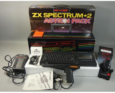 A boxed Sinclair ZX Spectrum+2 Action Pack, with power supply unit, television lead, manual, light gun with games and boxed j