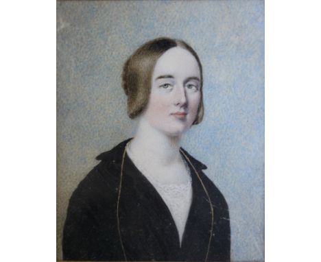 A LATE 19TH / EARLY 20TH CENTURY PORTRAIT MINIATURE OF A YOUNG WOMAN IN A BLACK COAT, with gilt mount in a red leather case, 