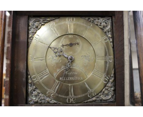 A 19TH CENTURY OAK AND MAHOGANY CROSSBANDED BRASS FACED LONGCASE CLOCK BY HARRIS OF WELLINGTON, the brass face with 30 hour m
