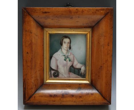 A PORTRAIT MINIATURE OF A SEATED YOUNG LADY IN A PINK DRESS WITH GREEN RIBBON, in maple frame, indistinctly signed and dated 