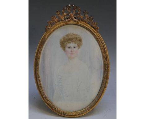 A LATE 19TH / EARLY 20TH CENTURY OVAL PORTRAIT MINIATURE OF A LADY WITH BLOND HAIR IN A WHITE DRESS, in oval decorative gilt 