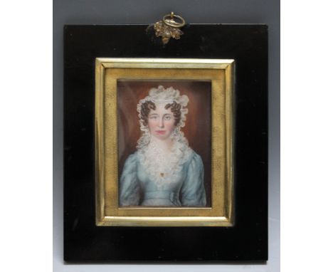 A 19TH CENTURY PORTRAIT MINIATURE OF A LADY IN A BLUE DRESS AND WHITE LACE BONNET, in a black frame with acorn finial, unsign