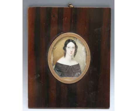 A 19TH CENTURY OVAL PORTRAIT MINIATURE OF A YOUNG LADY WITH BLACK HAIR, in fruitwood frame, unsigned, framed and glazed, 7 x 