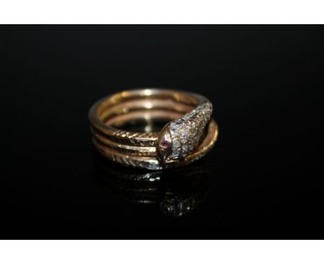 A 9 CT GOLD DIAMOND SET 'SNAKE' RING, with ruby set eyes, approx weight, 11g, ring size R