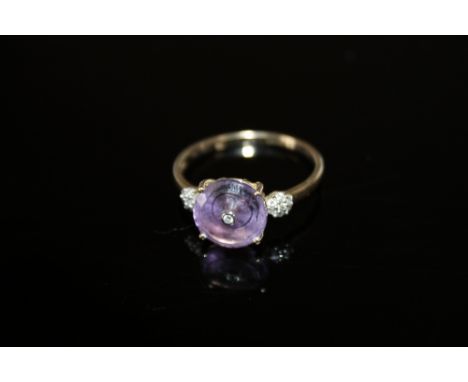 A HALLMARKED 9K GOLD AMETHYST AND DIAMOND RING,  the circular amethyst measuring approx 9 mm in diameter, ring size T 1/2