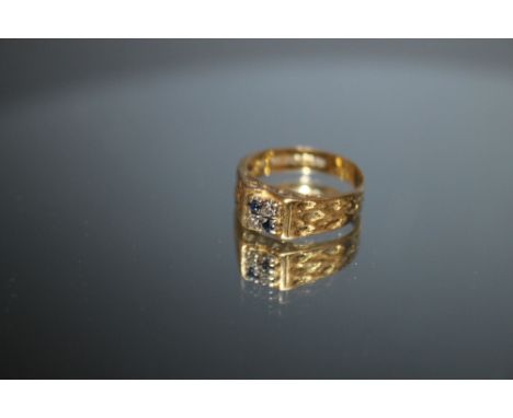 A HALLMARKED 18 CARAT GOLD RING, set with two small sapphires and two small diamonds on a pierced band, approx weight 3.9g, r