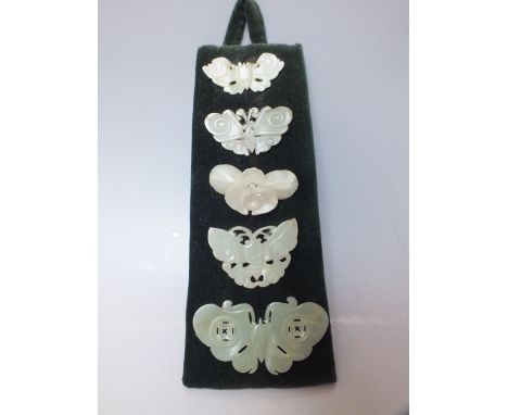 A COLLECTION OF FIVE CHINESE CELADON JADE CARVED  INSECT / MOTH PLAQUES, in varying sizes, finely carved in shallow relief wi