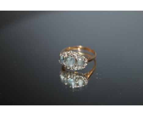 A HALLMARKED 18 CARAT GOLD THREE STONE AQUAMARINE AND DIAMOND RING, approx weight 4.6g, ring size N