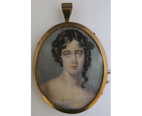 A LATE 19TH / EARLY 20TH CENTURY OVAL PORTRAIT MINIATURE OF A GIRL WITH BLACK HAIR, in an oval gilt metal frame, unsigned, fr