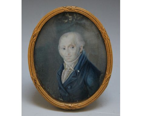 A LATE 19TH / EARLY 20TH CENTURY OVAL PORTRAIT MINIATURE OF A GENTLEMAN IN A BLUE COAT, in an oval gilt metal frame with stru