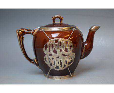 A SILVER MOUNTED TREACLE GLAZED TEAPOT,  having internal ceramic infuser a/f, mounts stamped 'sterling' H 15 cm 