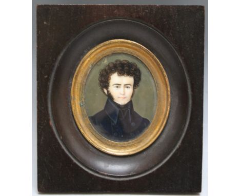 A LATE 19TH / EARLY 20TH CENTURY OVAL MINIATURE PORTRAIT STUDY OF A MAN IN A HIGH COLLARED BLUE COAT, in an ebonised, unsigne