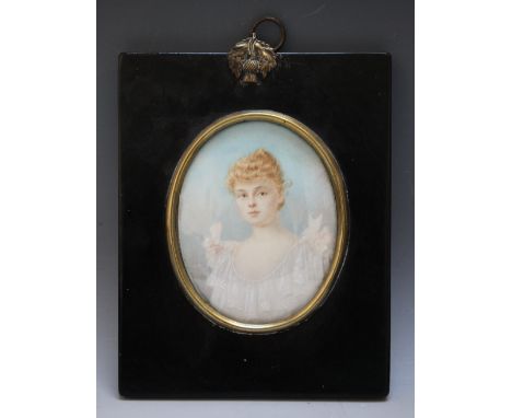 A LATE 19TH / EARLY 20TH CENTURY OVAL PORTRAIT MINIATURE OF A YOUNG LADY IN A WHITE DRESS, in black framed with acorn finial,