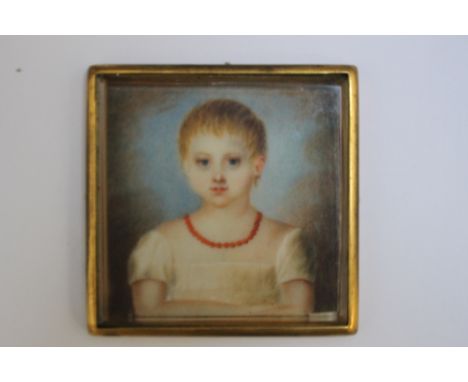 A 19TH CENTURY PORTRAIT MINIATURE OF A YOUNG GIRL WITH RED NECKLACE AND WHITE DRESS, in a gilt metal frame, unsigned, framed 