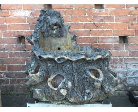 A LARGE 19TH CENTURY TREACLE GLAZE GARDEN PLANTER, modelled as a tree trunk with numerous pockets to the outside, also with a