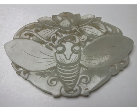 A CHINESE CELADON JADE CARVED AND PIERCED INSECT / MOTH PLAQUE, finely carved in shallow relief with typical decoration, W 11