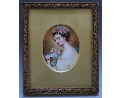 A LATE 19TH / EARLY 20TH CENTURY OVAL PORTRAIT MINIATURE OF A YOUNG LADY WITH A BUNCH OF FLOWERS, in gold wooden framed, unsi