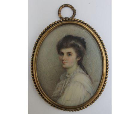 M. D. A late 19th / early 20th century oval portrait miniature of a lady in a white dress, in gilt metal framed, signed with 