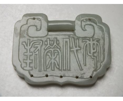 A LARGE CHINESE CELADON JADE BUCKLE / PENDANT, finely carved in shallow relief with bird and foliate decoration, the reverse 