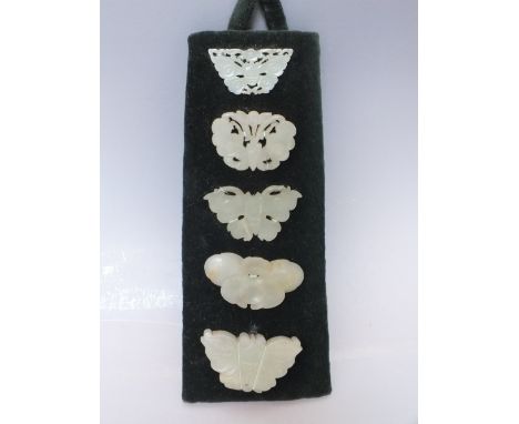 A COLLECTION OF FIVE CHINESE CELADON JADE CARVED  INSECT / MOTH PLAQUES, in varying sizes, finely carved in shallow relief wi