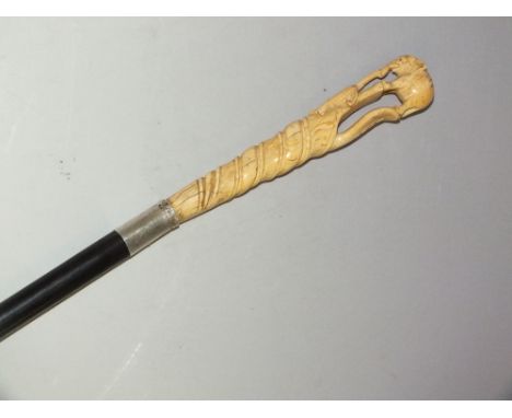 A LATE 19TH CENTURY IVORY HANDLED WALKING STICK, the handle carved as an elephant on a cobra, with ivory ferrule, L 90 cm