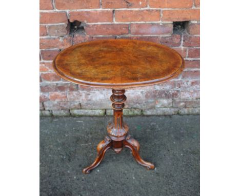 A VICTORIAN WALNUT OCCASIONAL TABLE, the oval top raised on a fluted column and tripod feet, H 72 cm, W 62 cm