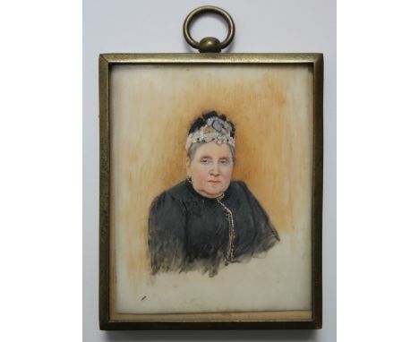 A LATE 19TH / EARLY 20TH CENTURY PORTRAIT MINIATURE OF A LADY IN A BLACK DRESS, in a gilt metal framed, unsigned, framed and 