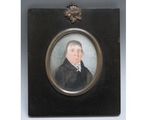 A LATE 19TH CENTURY OVAL PORTRAIT MINIATURE OF A GENTLEMAN IN BLACK COAT WITH WHITE CRAVAT, in black framed with acorn finial