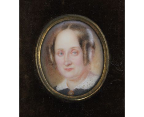 A LATE 19TH / EARLY 20TH CENTURY OVAL PORTRAIT MINIATURE OF A LADY WITH RINGLETS IN HER HAIR, in a leather frame, unsigned, f