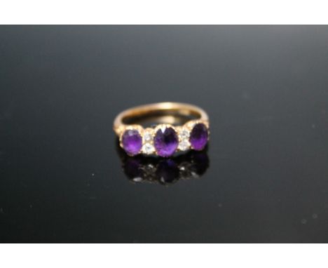 AN ORNATE 18 CT THREE STONE AMETHYST AND DIAMOND RING, approx weight 3.6g, ring size N