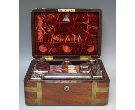 A 19TH CENTURY ROSEWOOD FITTED DRESSING CASE WITH AN ASSORTMENT OF SILVER HALLMARKED BOTTLES AND BOXES, the brass bound box w