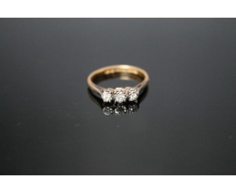 AN 18 CARAT GOLD THREE STONE DIAMOND RING, ring size LCondition Report:`