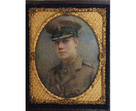 AN EARLY 20TH CENTURY OVAL PORTRAIT MINIATURE OF A WW1 ARMY OFFICER, in an oval decorative gilt metal frame in a leather case