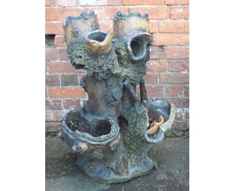A 19TH CENTURY TREACLE GLAZE GARDEN PLANTER, modelled as a tree trunk with numerous pockets to the outside, H 80 cm, W 54 cm 