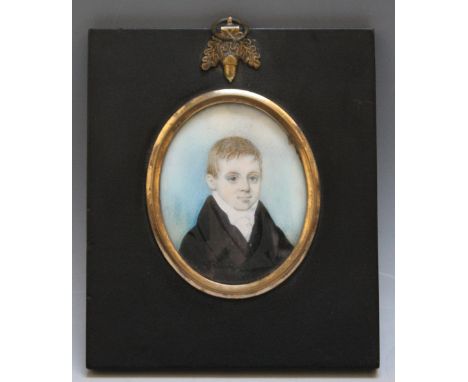 A 19TH CENTURY OVAL PORTRAIT MINIATURE OF A BOY IN A BLACK COAT, in a black frame with acorn finial, unsigned, indistinctly i