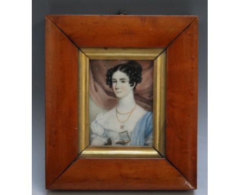 A LATE 19TH / EARLY 20TH CENTURY PORTRAIT MINIATURE OF A LADY IN A  BLUE DRESS WITH WHITE SHAWL HOLDING A BOOK, in a maple fr