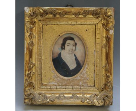 A 19TH CENTURY OVAL PORTRAIT MINIATURE OF A GENTLEMAN IN A BLUE COAT AND WHITE CRAVAT, in swept gold framed, unsigned, framed