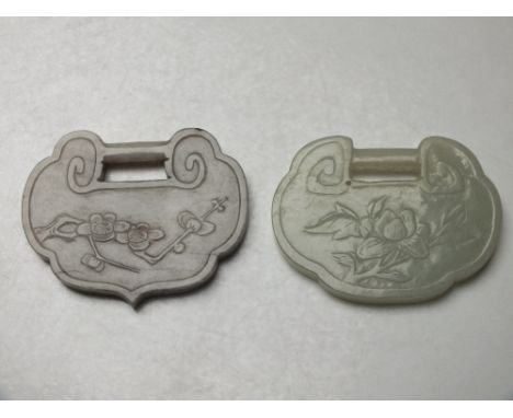 A CHINESE CELADON JADE LOCK PENDANT, given as a token of long life, finely carved in shallow relief with flower and foliate d