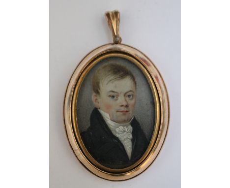 A LATE 19TH / EARLY 20TH CENTURY OVAL PORTRAIT MINIATURE OF A YOUNG MAN IN A BLACK COAT AND WHITE CRAVAT, in an oval gilt met
