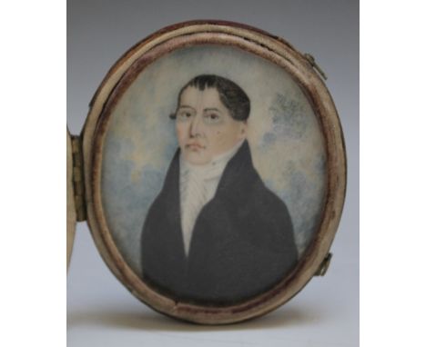 A 19TH CENTURY OVAL PORTRAIT MINIATURE OF A GENTLEMAN IN A BLACK COAT, in an oval leather case, unsigned, framed and glazed, 