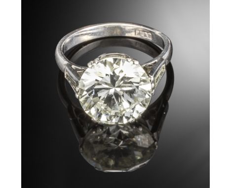 A diamond solitaire ring, the round brilliant-cut diamond weighs 5.30cts and is set with tapered baguette-shaped shoulders in