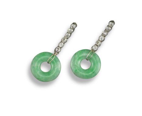 A pair of jade and diamond drop earrings, each circular jade disc suspends from an articulated line of old circular-cut diamo